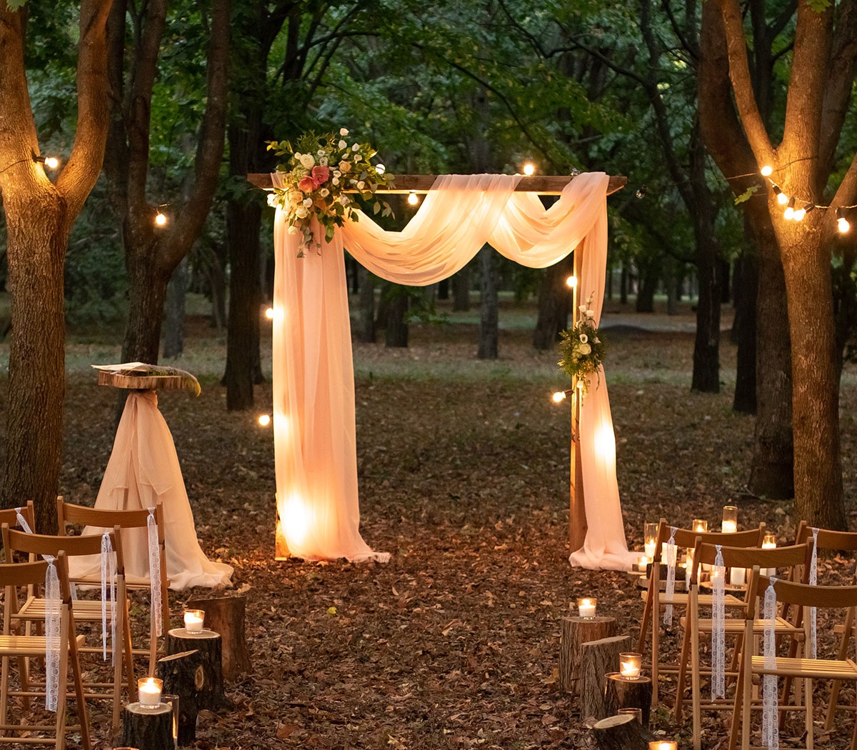 Intimate Ceremony Setting Lit with Candles & Globe String Lights
