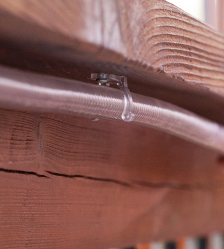 mounting clips hold rope light in place under deck railings